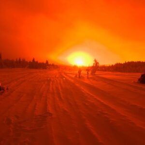 A bright red sun coming up over the Swedish landscape